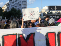 A young Tunisian woman raises a placard that reads in Arabic, ''Down with Decree 54,'' during a demonstration organized by the Tunisian Netw...