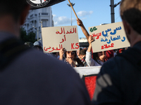 Demonstrators raise a placard that reads in Arabic, ''justice or chaos,'' during a demonstration organized by the Tunisian Network for Right...