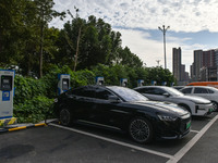 Electric vehicles charge at an electric vehicle charging station on a street in Fuyang, China, on October 5, 2024. (