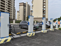 Electric vehicles charge at an electric vehicle charging station on a street in Fuyang, China, on October 5, 2024. (