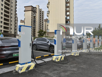 Electric vehicles charge at an electric vehicle charging station on a street in Fuyang, China, on October 5, 2024. (