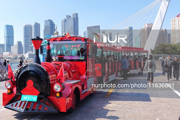 Tourists visit the International Sailing Center in Qingdao, China, on October 3, 2024. 