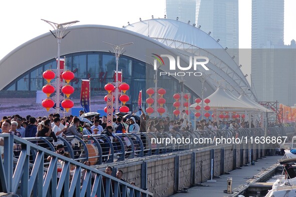 Tourists visit the International Sailing Center in Qingdao, China, on October 3, 2024. 