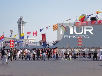 Tourists visit the International Sailing Center in Qingdao, China, on October 3, 2024. (