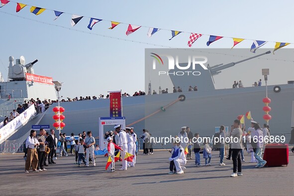 Tourists visit the International Sailing Center in Qingdao, China, on October 3, 2024. 