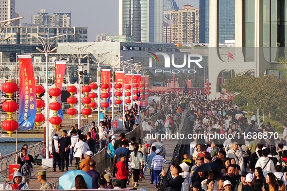 Tourists visit the International Sailing Center in Qingdao, China, on October 3, 2024. 