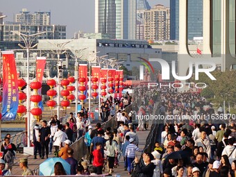 Tourists visit the International Sailing Center in Qingdao, China, on October 3, 2024. (