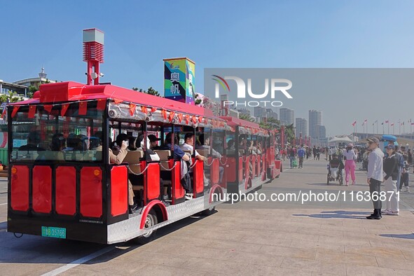 Tourists visit the International Sailing Center in Qingdao, China, on October 3, 2024. 