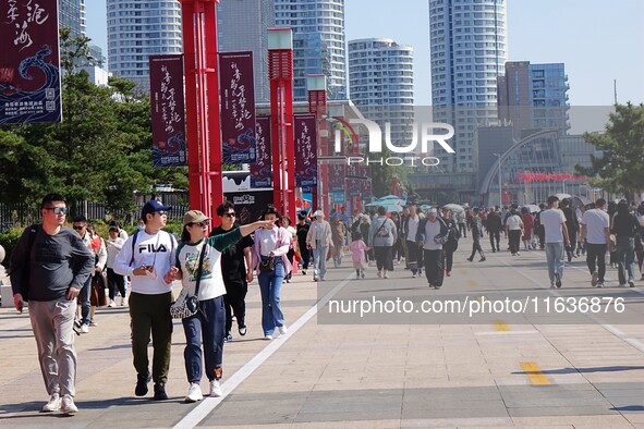 Tourists visit the International Sailing Center in Qingdao, China, on October 3, 2024. 