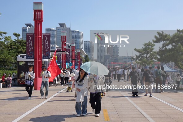 Tourists visit the International Sailing Center in Qingdao, China, on October 3, 2024. 