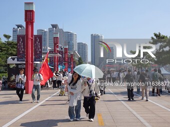 Tourists visit the International Sailing Center in Qingdao, China, on October 3, 2024. (