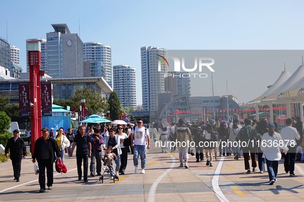 Tourists visit the International Sailing Center in Qingdao, China, on October 3, 2024. 