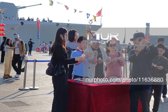 Tourists visit the International Sailing Center in Qingdao, China, on October 3, 2024. 