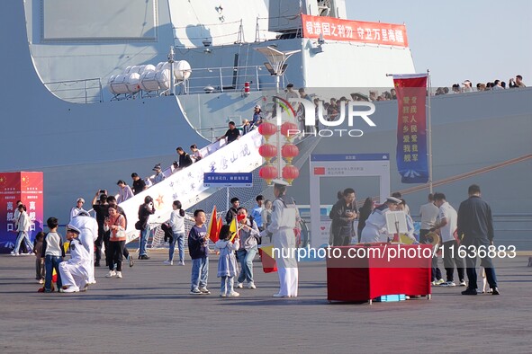 Tourists visit the International Sailing Center in Qingdao, China, on October 3, 2024. 