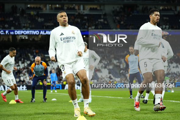 Kylian Mbappe centre-forward of Real Madrid and France and Jude Bellingham central midfield of Real Madrid and England during the warm-up be...