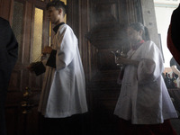 Devotees raise their pets to receive holy water blessings during a mass to bless pets and animals as part of 'World Animal Day' at Iglesia d...