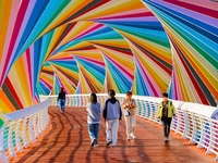 Tourists visit the Rainbow Bridge by Tangdao Bay in the West Coast New Area of Qingdao, East China's Shandong province, on October 5, 2024....