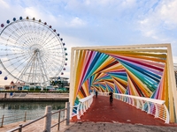 Tourists visit the Rainbow Bridge by Tangdao Bay in the West Coast New Area of Qingdao, East China's Shandong province, on October 5, 2024....