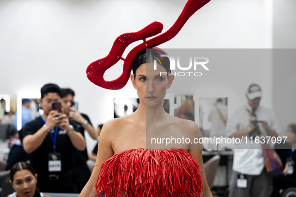 Supermodel Cindy Sirinya Bishop prepares backstage before walking on the runway during Day 3 of Bangkok International Fashion Week at Siam P...