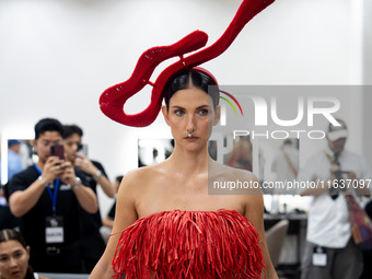 Supermodel Cindy Sirinya Bishop prepares backstage before walking on the runway during Day 3 of Bangkok International Fashion Week at Siam P...