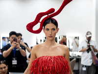 Supermodel Cindy Sirinya Bishop prepares backstage before walking on the runway during Day 3 of Bangkok International Fashion Week at Siam P...