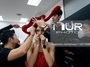 Supermodel Cindy Sirinya Bishop prepares backstage before walking on the runway during Day 3 of Bangkok International Fashion Week at Siam P...