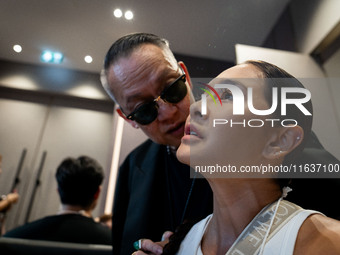 Metinee 'Lukkade' Kingpayom speaks to the media backstage before walking on the runway during Day 3 of Bangkok International Fashion Week at...