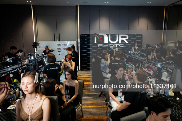 Models prepare backstage before walking on the runway during Day 3 of Bangkok International Fashion Week at Siam Paragon in Bangkok, Thailan...