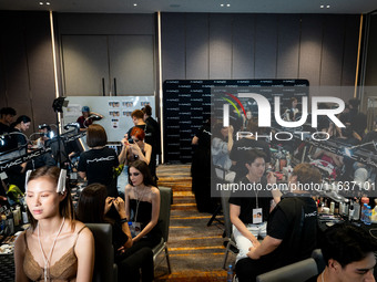 Models prepare backstage before walking on the runway during Day 3 of Bangkok International Fashion Week at Siam Paragon in Bangkok, Thailan...