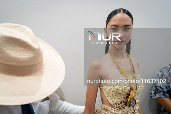 Models wear creations by ISSUE and get ready backstage before walking on the runway during Day 3 of Bangkok International Fashion Week at Si...