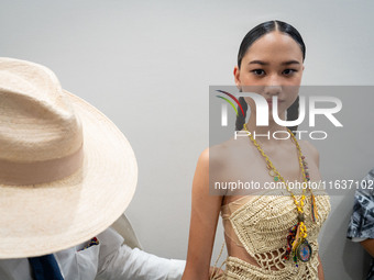 Models wear creations by ISSUE and get ready backstage before walking on the runway during Day 3 of Bangkok International Fashion Week at Si...