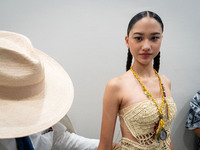 Models wear creations by ISSUE and get ready backstage before walking on the runway during Day 3 of Bangkok International Fashion Week at Si...