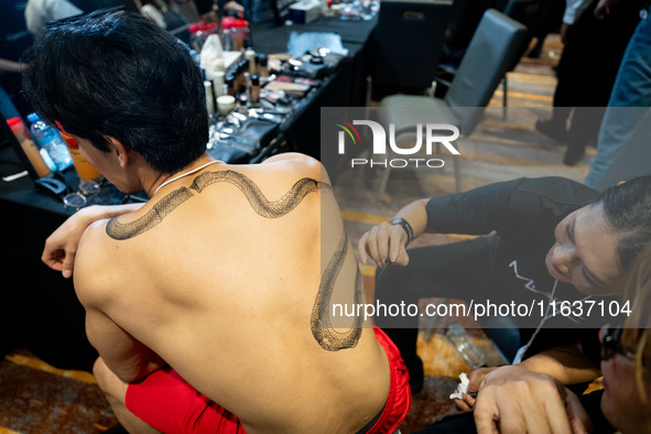 Models wear creations by ISSUE and get ready backstage before walking on the runway during Day 3 of Bangkok International Fashion Week at Si...