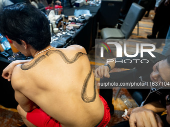 Models wear creations by ISSUE and get ready backstage before walking on the runway during Day 3 of Bangkok International Fashion Week at Si...