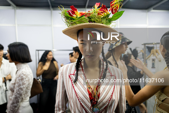 Models wear creations by ISSUE and get ready backstage before walking on the runway during Day 3 of Bangkok International Fashion Week at Si...