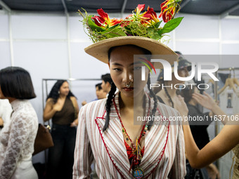 Models wear creations by ISSUE and get ready backstage before walking on the runway during Day 3 of Bangkok International Fashion Week at Si...