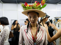 Models wear creations by ISSUE and get ready backstage before walking on the runway during Day 3 of Bangkok International Fashion Week at Si...