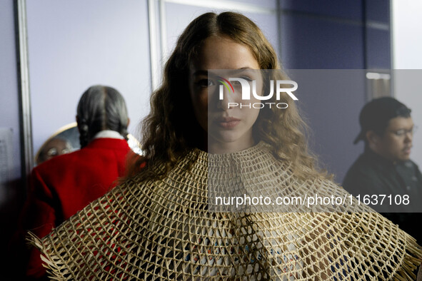 Models wear creations by ISSUE and get ready backstage before walking on the runway during Day 3 of Bangkok International Fashion Week at Si...