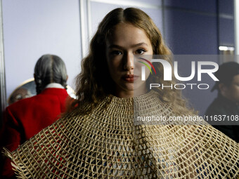 Models wear creations by ISSUE and get ready backstage before walking on the runway during Day 3 of Bangkok International Fashion Week at Si...