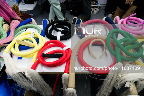 Fashion items that are part of the collection for ISSUE are on a table backstage before the runway show during Day 3 of Bangkok Internationa...