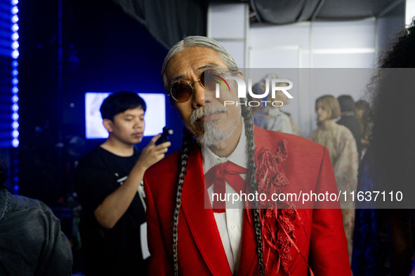 Models prepare backstage before walking on the runway during Day 3 of Bangkok International Fashion Week at Siam Paragon in Bangkok, Thailan...