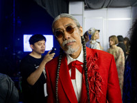 Models prepare backstage before walking on the runway during Day 3 of Bangkok International Fashion Week at Siam Paragon in Bangkok, Thailan...