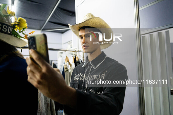 Models prepare backstage before walking on the runway during Day 3 of Bangkok International Fashion Week at Siam Paragon in Bangkok, Thailan...