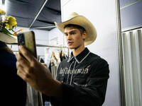 Models prepare backstage before walking on the runway during Day 3 of Bangkok International Fashion Week at Siam Paragon in Bangkok, Thailan...