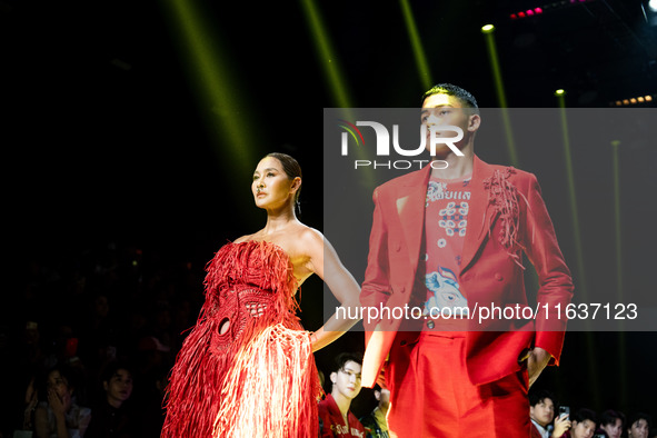 Metinee 'Lukkad' Kingpayom (L) walks the runway in a creation by ISSUE during Day 3 of Bangkok International Fashion Week at Siam Paragon in...