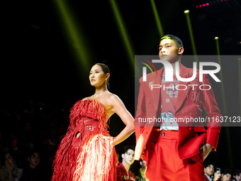 Metinee 'Lukkad' Kingpayom (L) walks the runway in a creation by ISSUE during Day 3 of Bangkok International Fashion Week at Siam Paragon in...