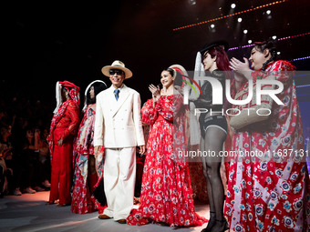 Models stand with Bhubawit 'Roj' Kritpholnara, designer of ISSUE, on the runway on Day 3 of Bangkok International Fashion Week at Siam Parag...