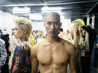 Models wear creations by POEM and get ready backstage before walking on the runway during Day 3 of Bangkok International Fashion Week at Sia...