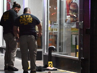 New York City Police Department crime scene investigators mark evidence discovered at the scene where former Governor of New York David Pate...