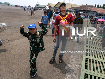 A number of residents visit the TNI Transport Aircraft Static Show event to commemorate the 79th Anniversary of the TNI at Husein Sastranega...